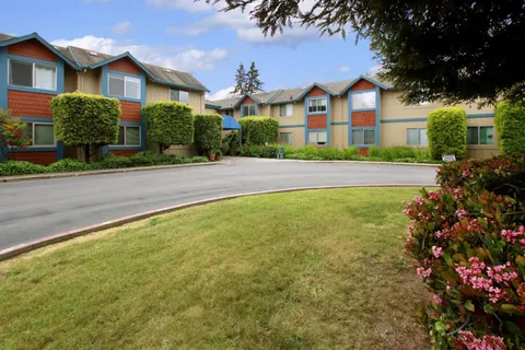a front view of a house with a yard and outdoor seating