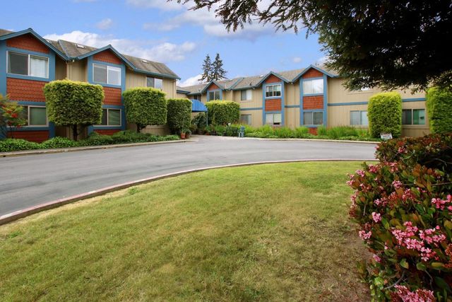 a front view of a house with a yard and outdoor seating