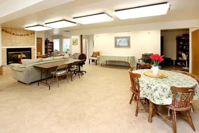 a dining room with furniture and window