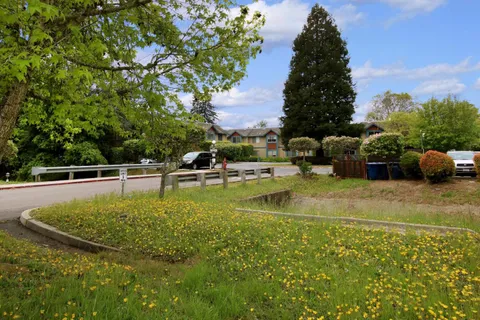 a view of a swimming pool with a yard and sitting area