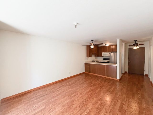 a view of a kitchen with wooden floor