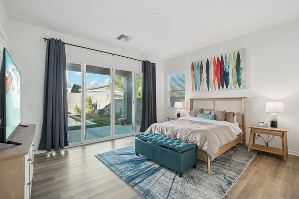 a bedroom with a large bed and a flat screen tv
