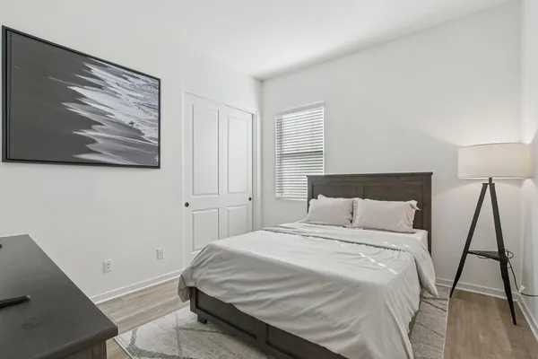 a bedroom with a bed and a rug
