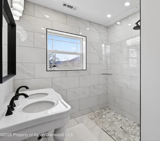 a bathroom with a sink a toilet and mirror