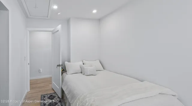 a bedroom with a bed and a mirror