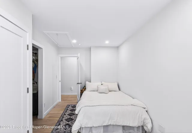 a large bed in a white room