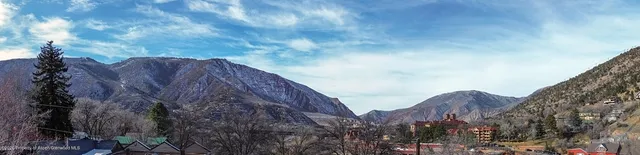 a view of backyard of house with seating space