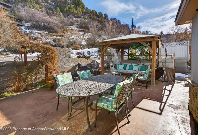 a view of a house with large windows and a small yard