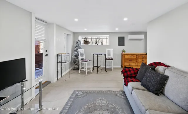 a living room with furniture and a flat screen tv