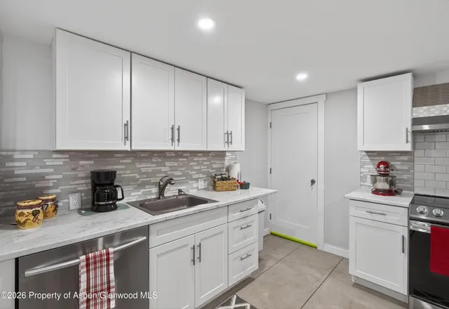 a kitchen with stainless steel appliances a refrigerator sink and cabinets