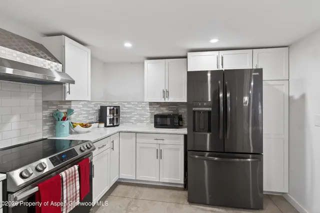 a kitchen with a refrigerator and a sink