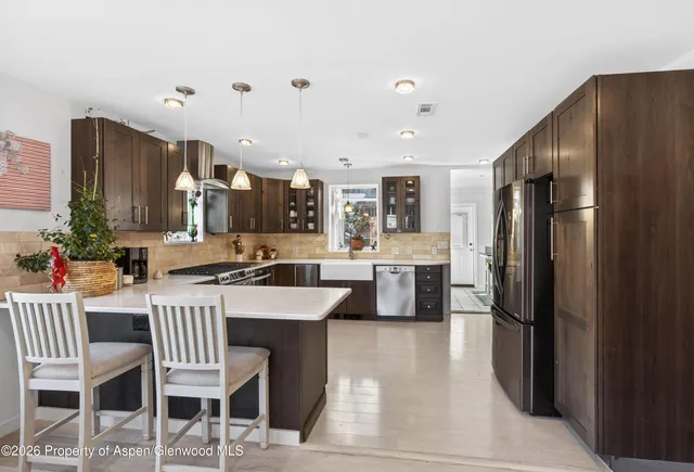 a large kitchen with a table and chairs