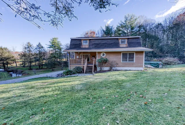 a view of a house with a backyard porch and sitting area