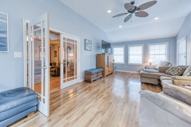 a living room with furniture and a chandelier