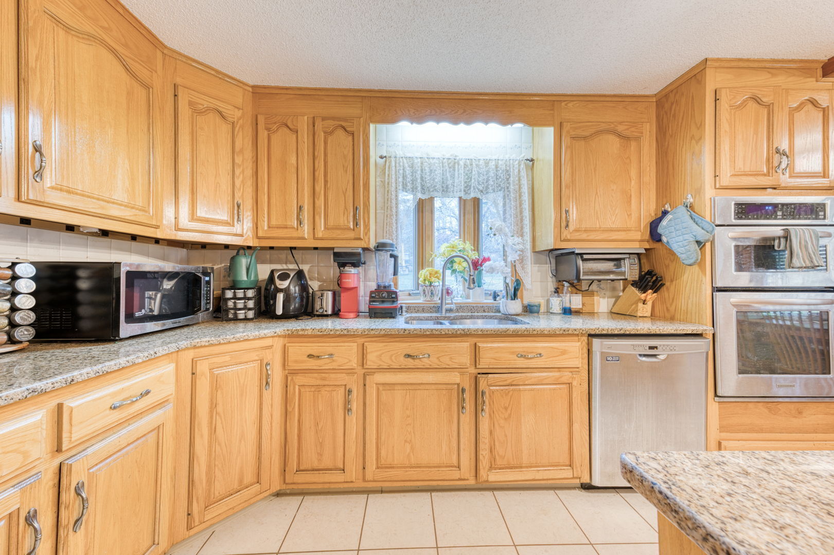 51 Devaux Road Torrington, CT 06790 - Photo 14 of 27 a kitchen with stainless steel appliances granite countertop a stove a sink and white cabinets
