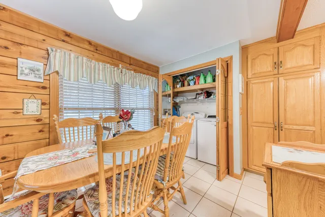 a dining room with furniture and a window