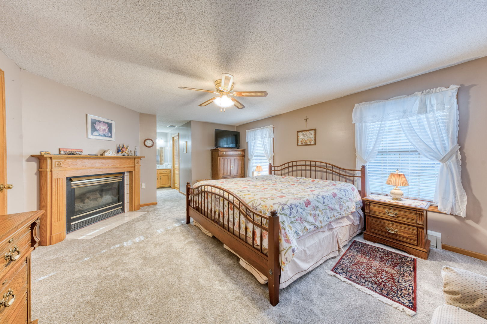 51 Devaux Road Torrington, CT 06790 - Photo 20 of 27 a spacious bedroom with a bed and a fireplace