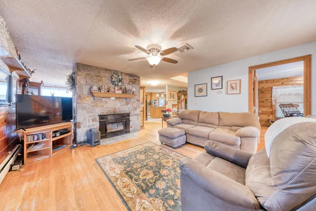 a living room with furniture a flat screen tv and a fireplace