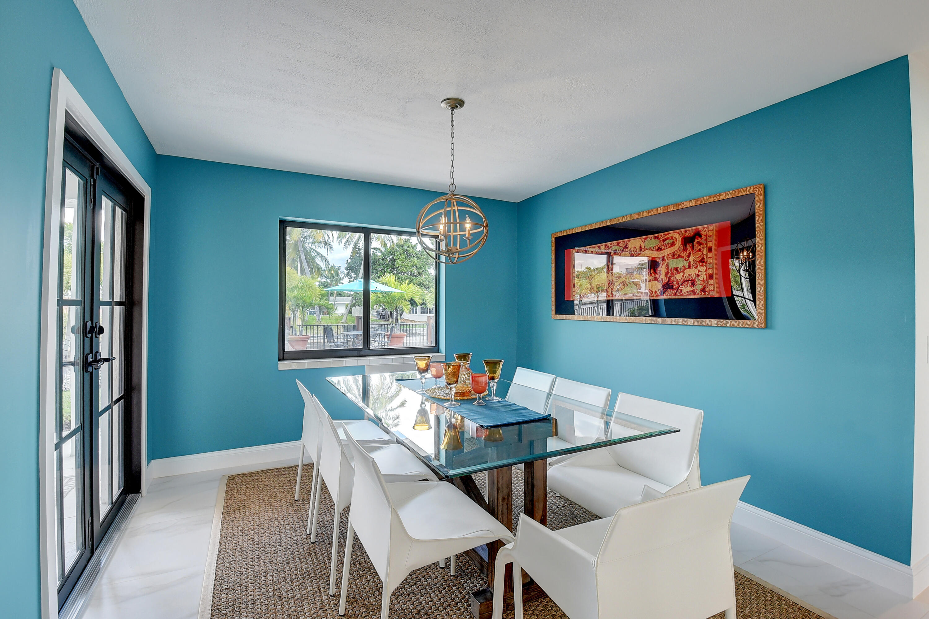 399 Southwest 15th Street Boca Raton, FL 33432 - Photo 17 of 49 a dining room with furniture a rug and a chandelier