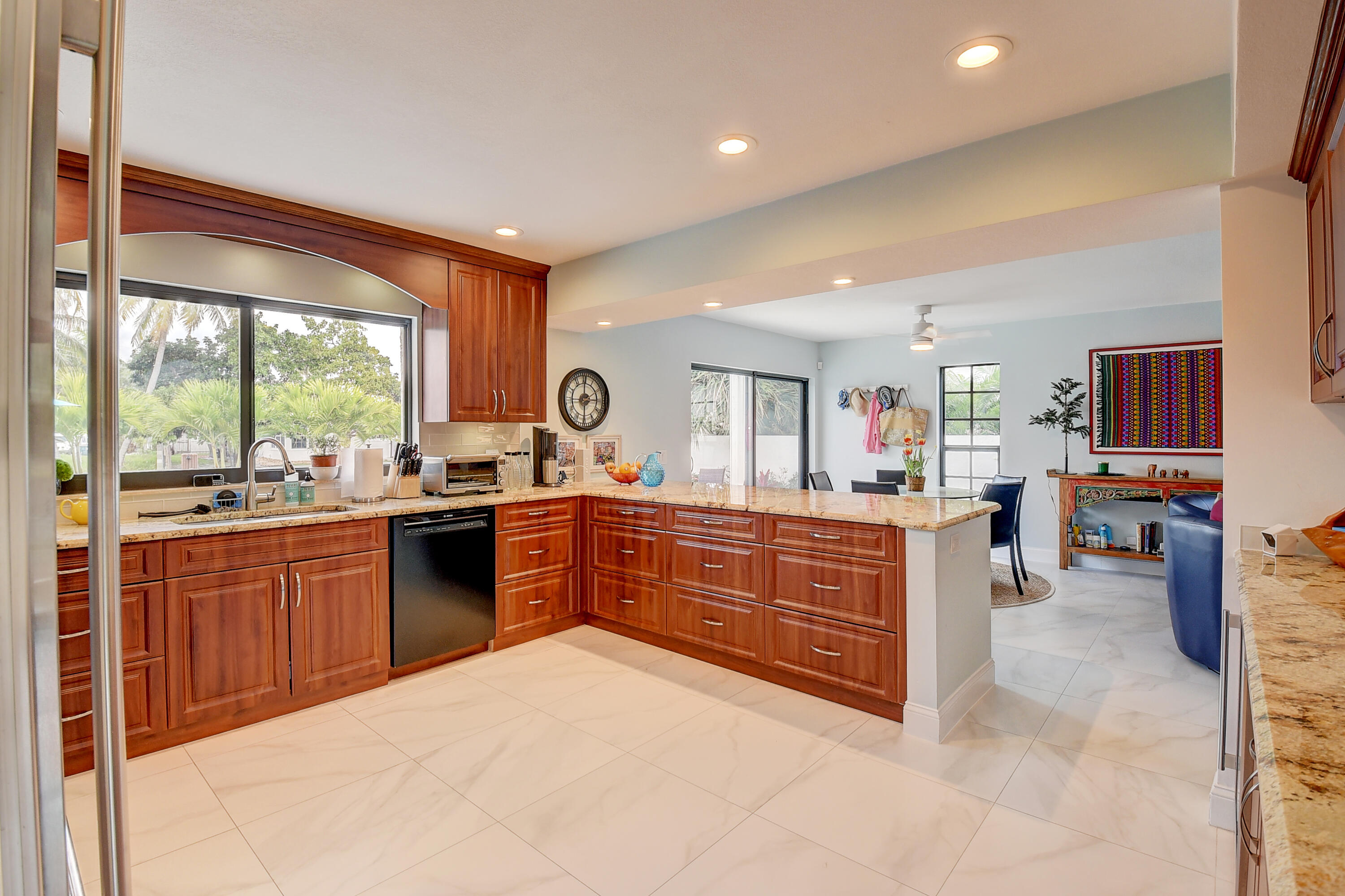 399 Southwest 15th Street Boca Raton, FL 33432 - Photo 19 of 49 a large kitchen with kitchen island granite countertop a large counter top space a sink a counter space and stainless steel appliances