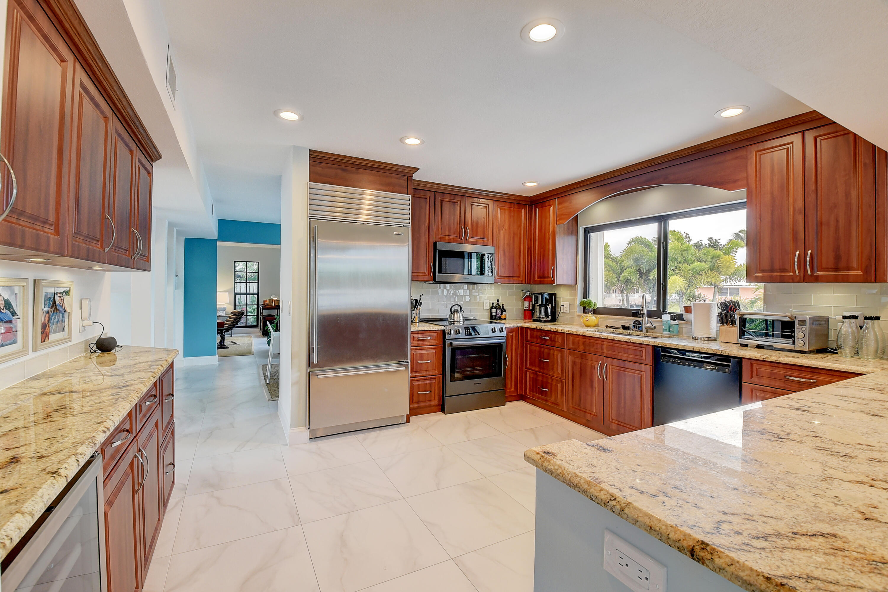 399 Southwest 15th Street Boca Raton, FL 33432 - Photo 21 of 49 a large kitchen with stainless steel appliances granite countertop a stove refrigerator sink and cabinets