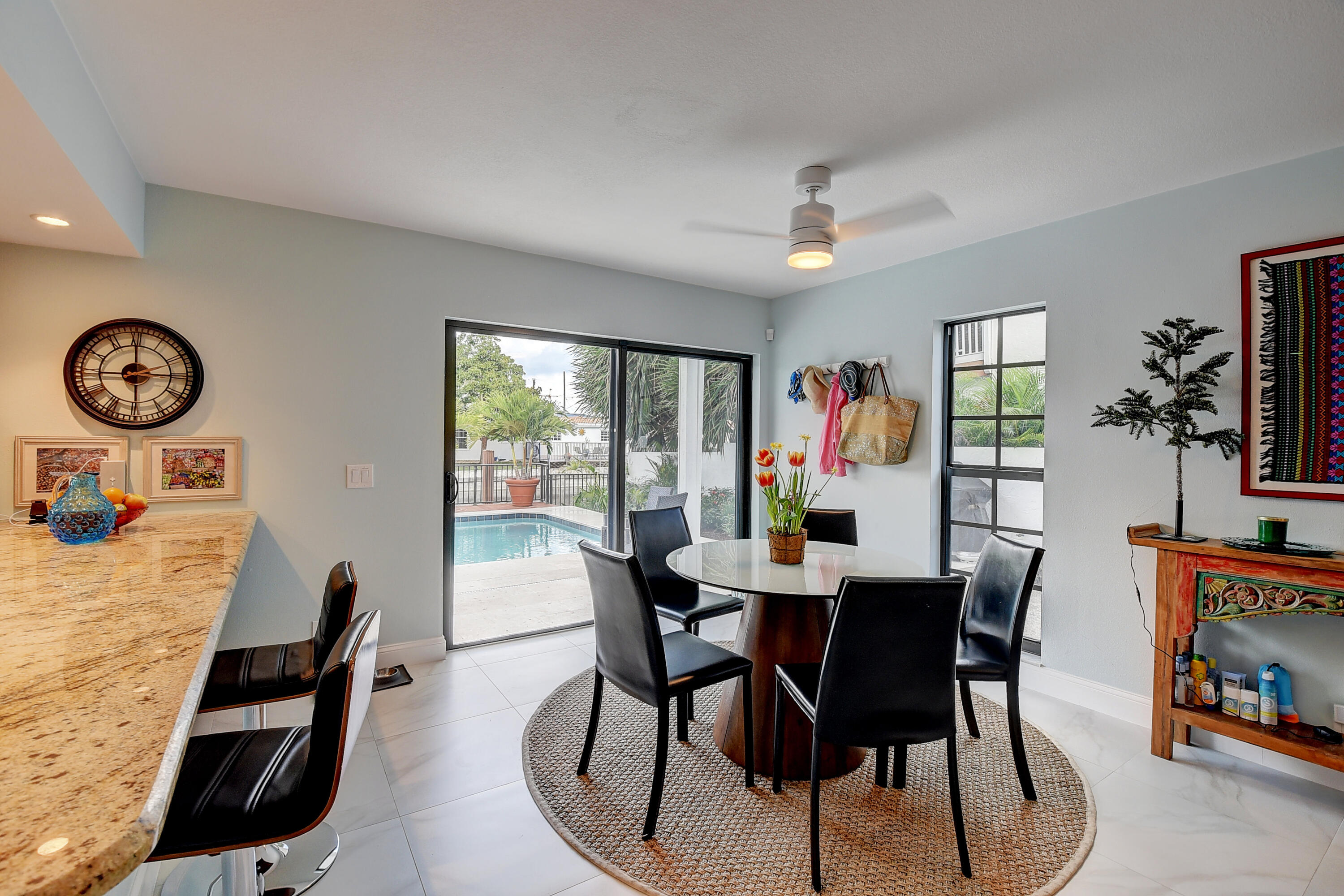 399 Southwest 15th Street Boca Raton, FL 33432 - Photo 24 of 49 a view of a dining room with furniture wooden floor and a window