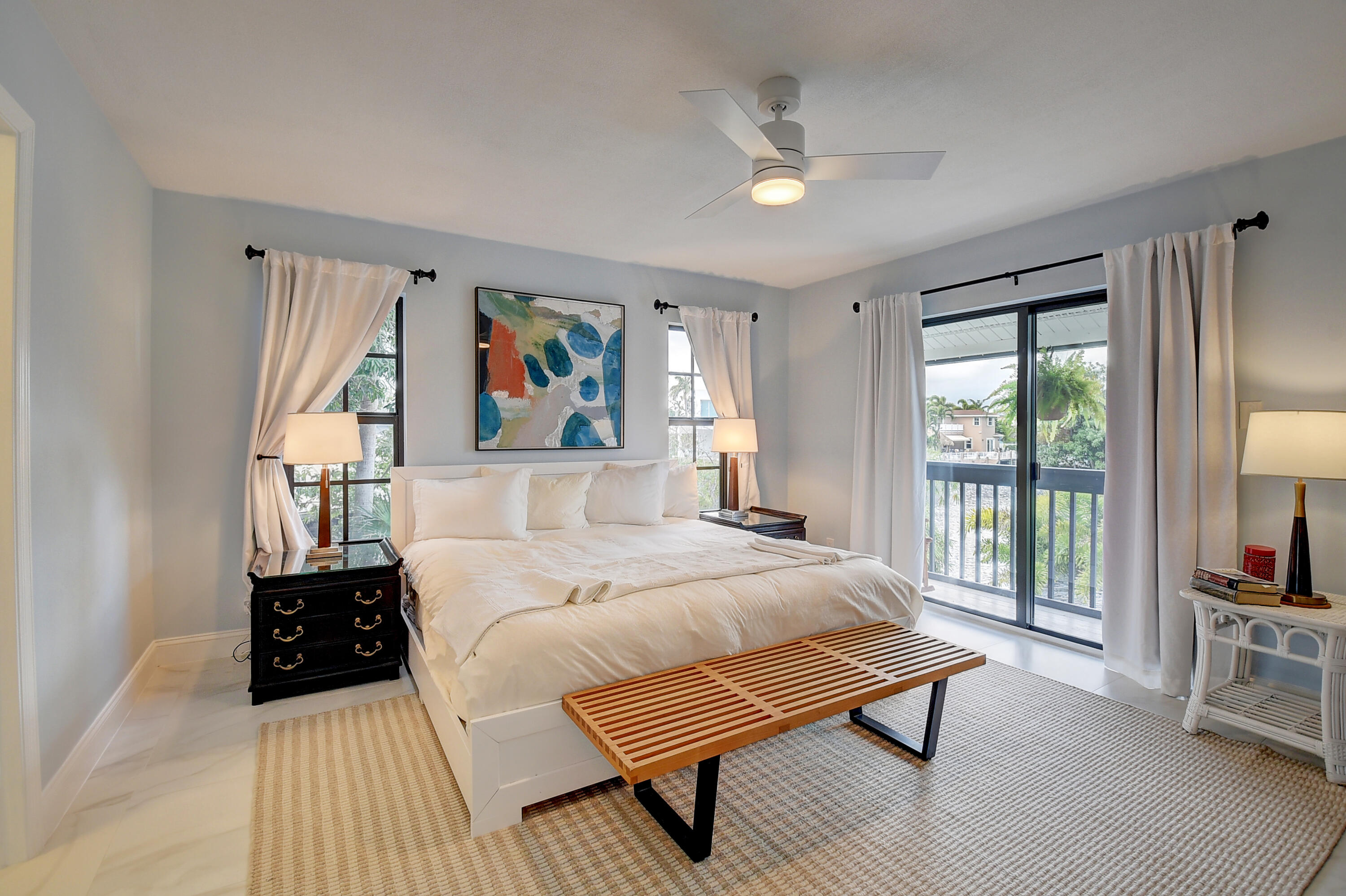 399 Southwest 15th Street Boca Raton, FL 33432 - Photo 29 of 49 a bedroom with a bed couch and a large window
