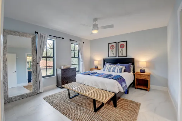 a spacious bedroom with a bed and glass door