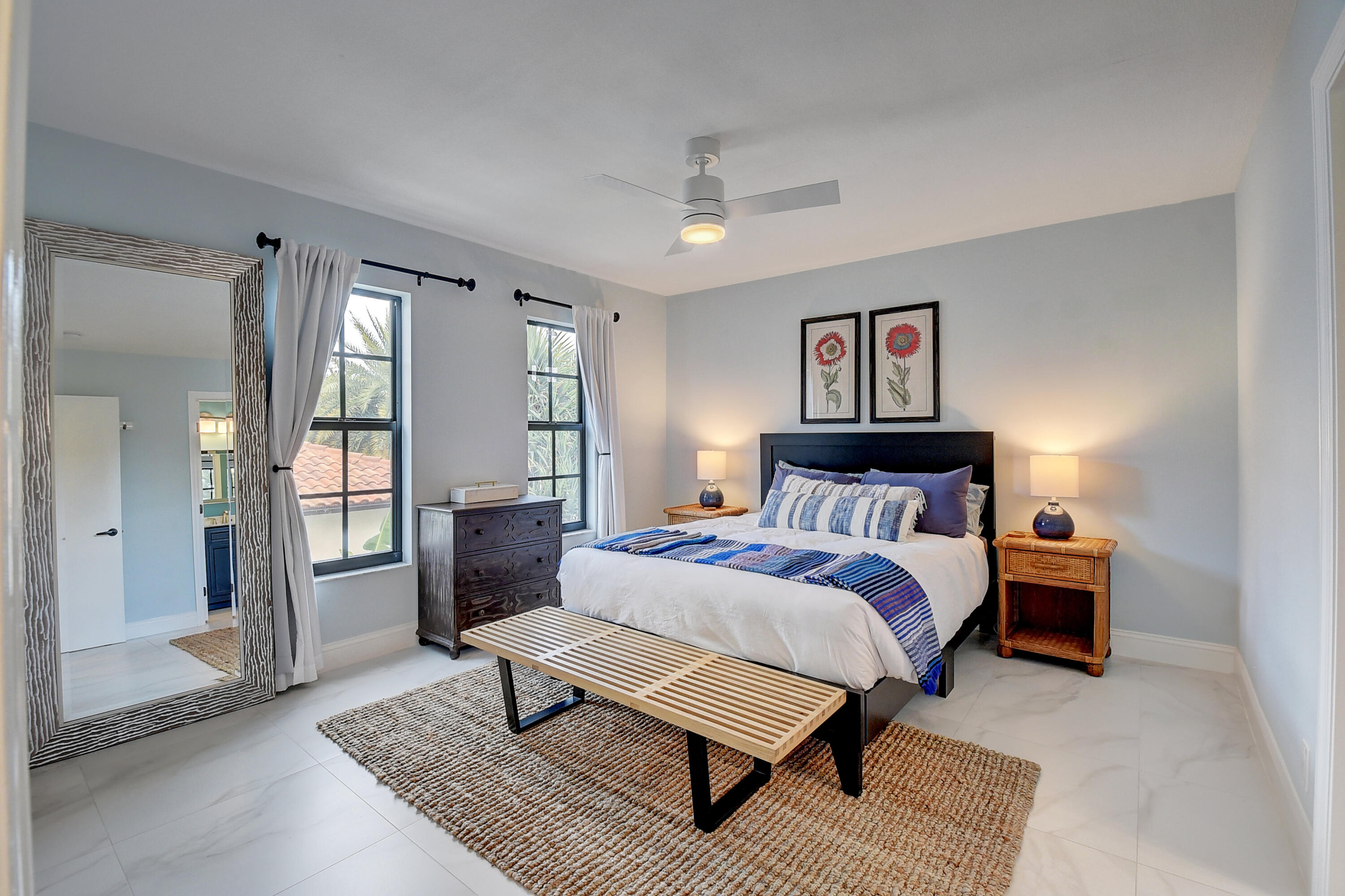 399 Southwest 15th Street Boca Raton, FL 33432 - Photo 32 of 49 a spacious bedroom with a bed and glass door