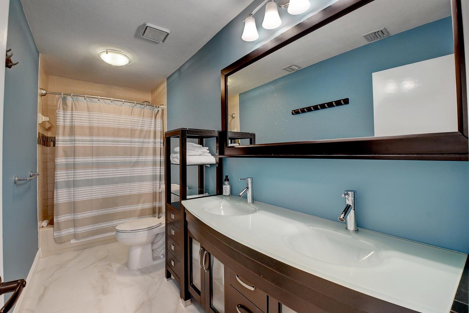 399 Southwest 15th Street Boca Raton, FL 33432 - Photo 33 of 49 a bathroom with a sink a toilet and shower