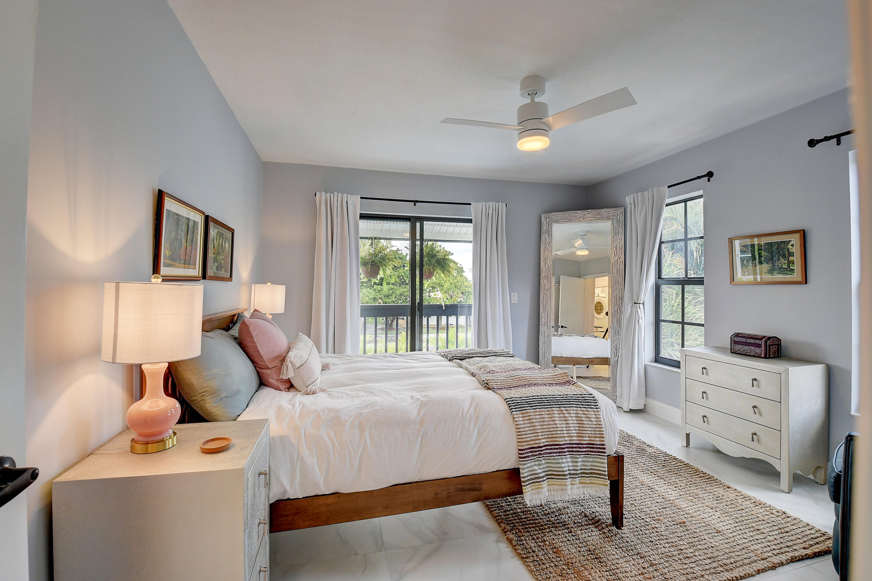 399 Southwest 15th Street Boca Raton, FL 33432 - Photo 34 of 49 a bedroom with a bed and wooden floor