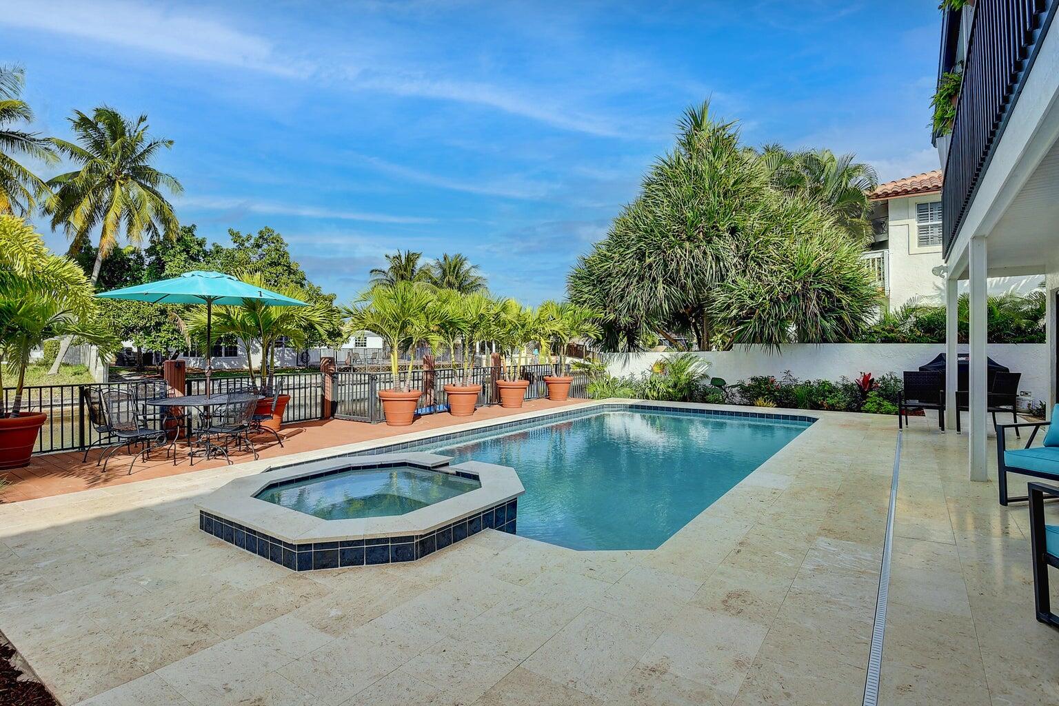 399 Southwest 15th Street Boca Raton, FL 33432 - Photo 45 of 49 a view of a swimming pool with chairs