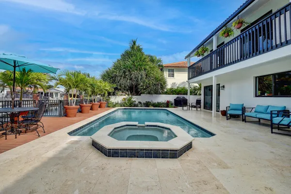 a swimming pool with outdoor seating and yard