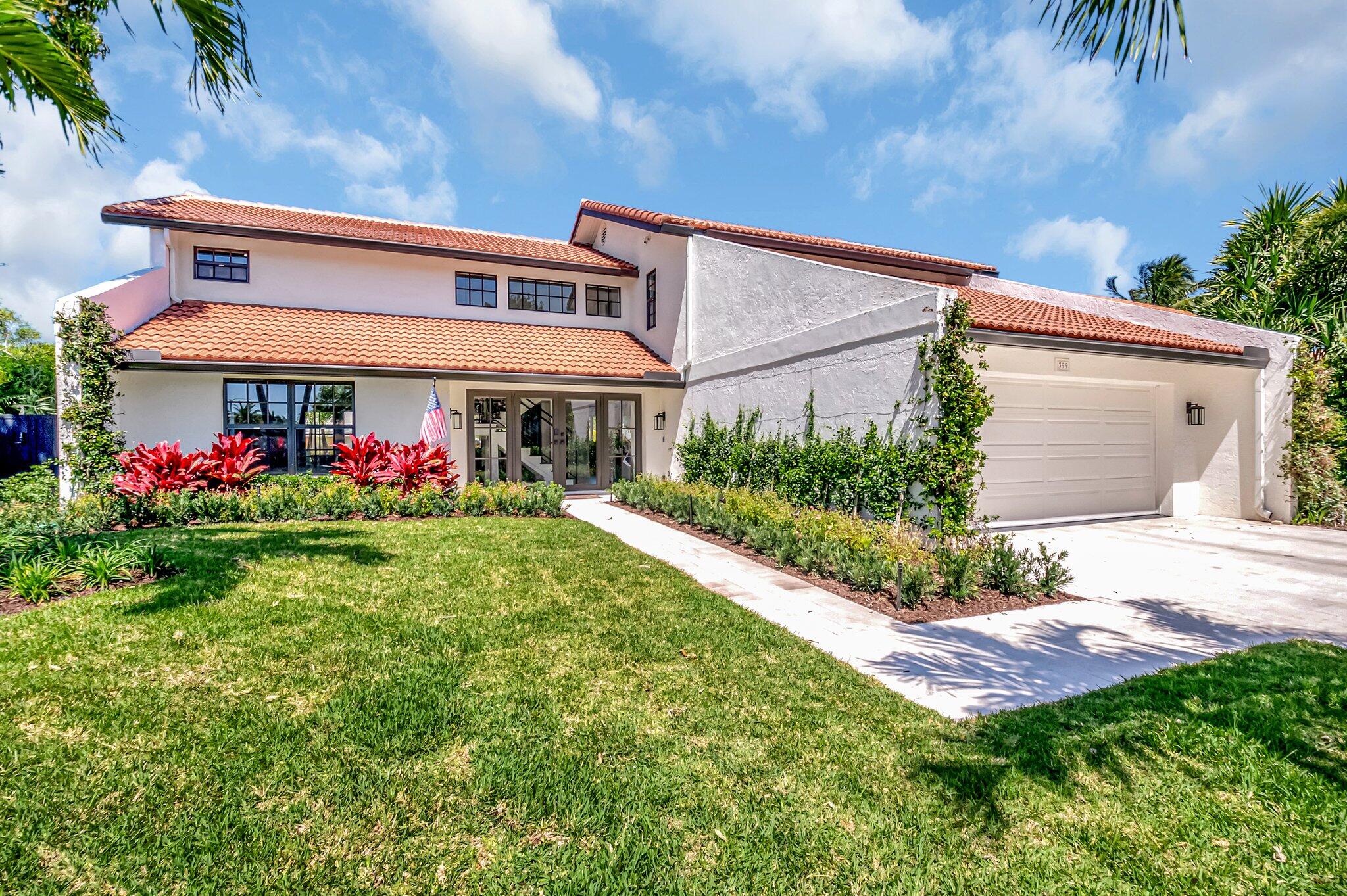 399 Southwest 15th Street Boca Raton, FL 33432 - Photo 48 of 49 a front view of a house with garden