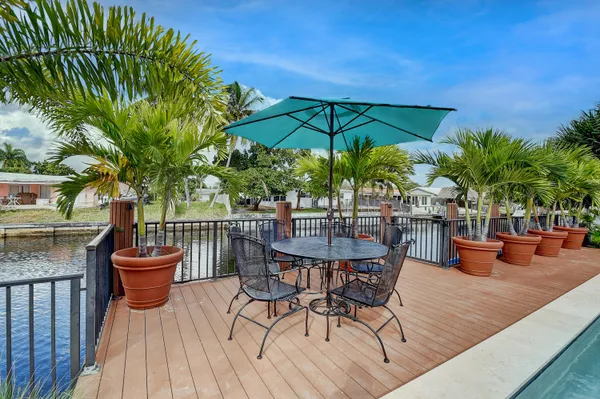 a view of a chair and tables in the patio