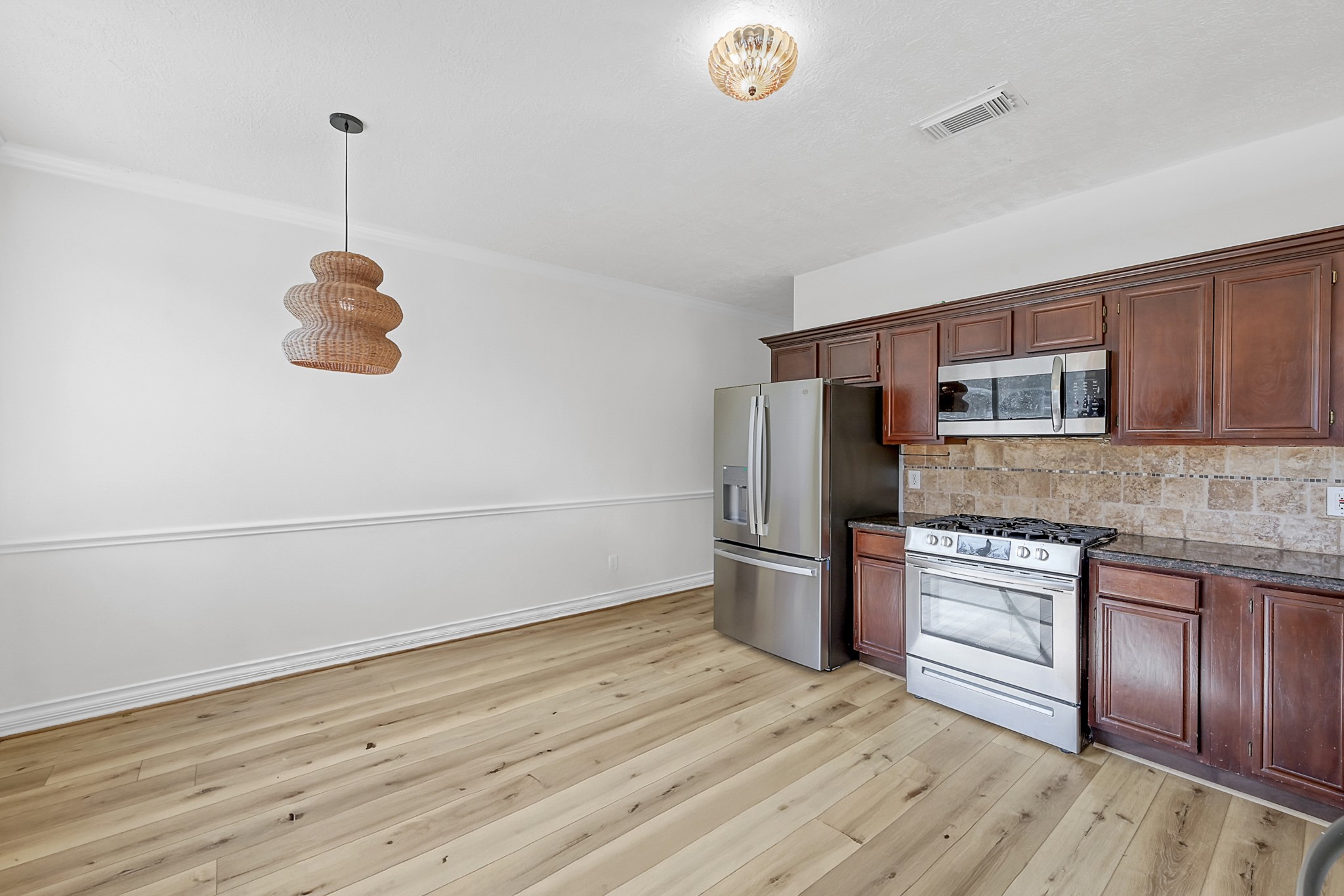 30818 Trinket Drive Spring, TX 77386 - Photo 12 of 29 a kitchen with stainless steel appliances granite countertop a refrigerator a stove and a wooden floors