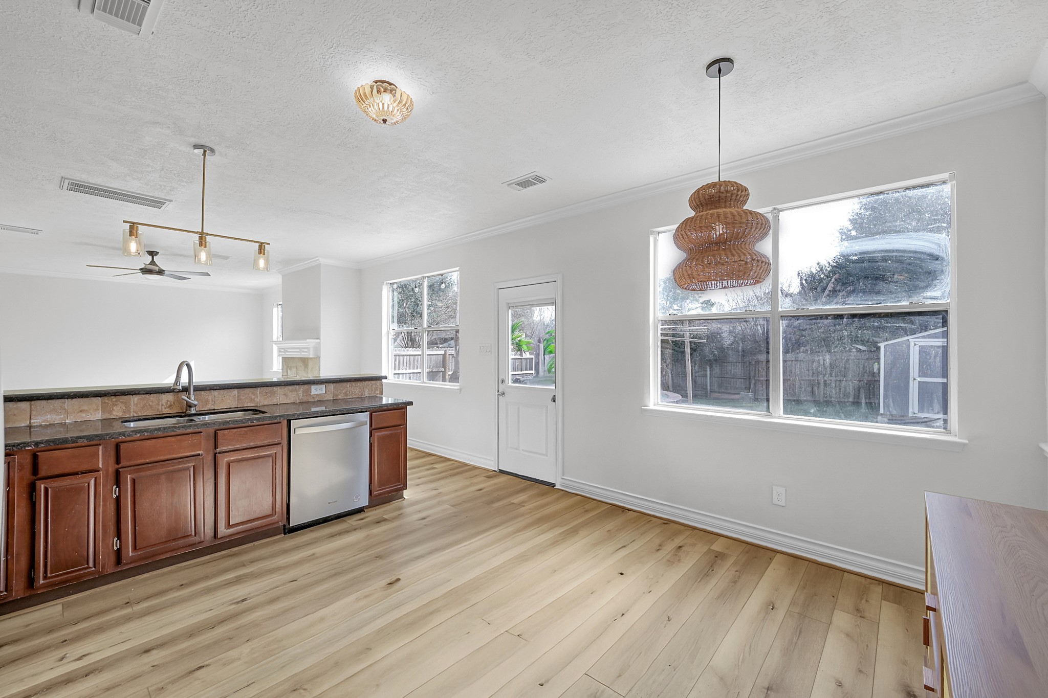 30818 Trinket Drive Spring, TX 77386 - Photo 13 of 29 a large kitchen with stainless steel appliances granite countertop a sink a window and wooden floor