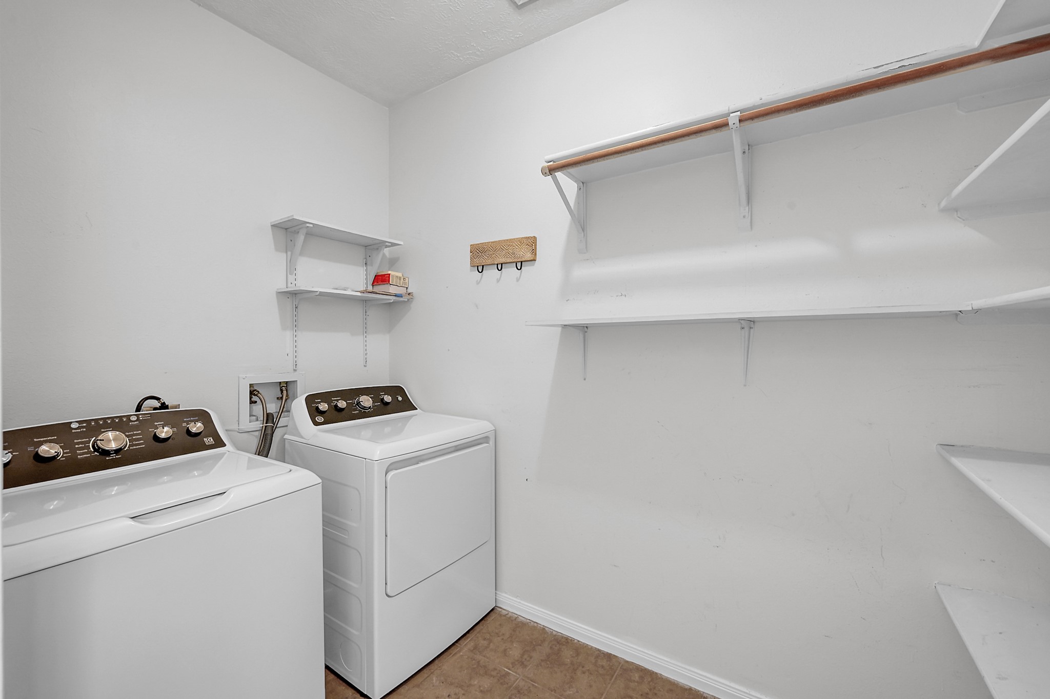 30818 Trinket Drive Spring, TX 77386 - Photo 18 of 29 a view of storage and utility room with washer and dryer