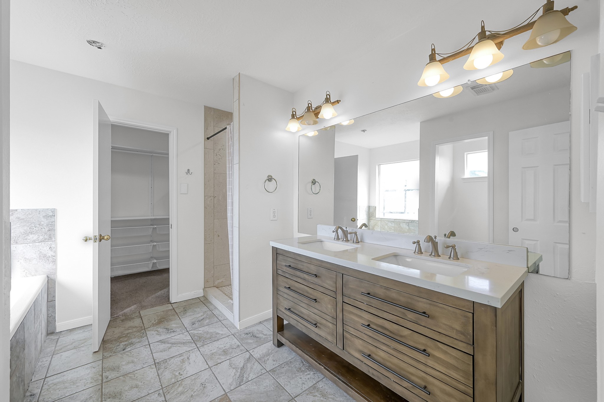 30818 Trinket Drive Spring, TX 77386 - Photo 21 of 29 a bathroom with a double vanity sink a mirror and a shower