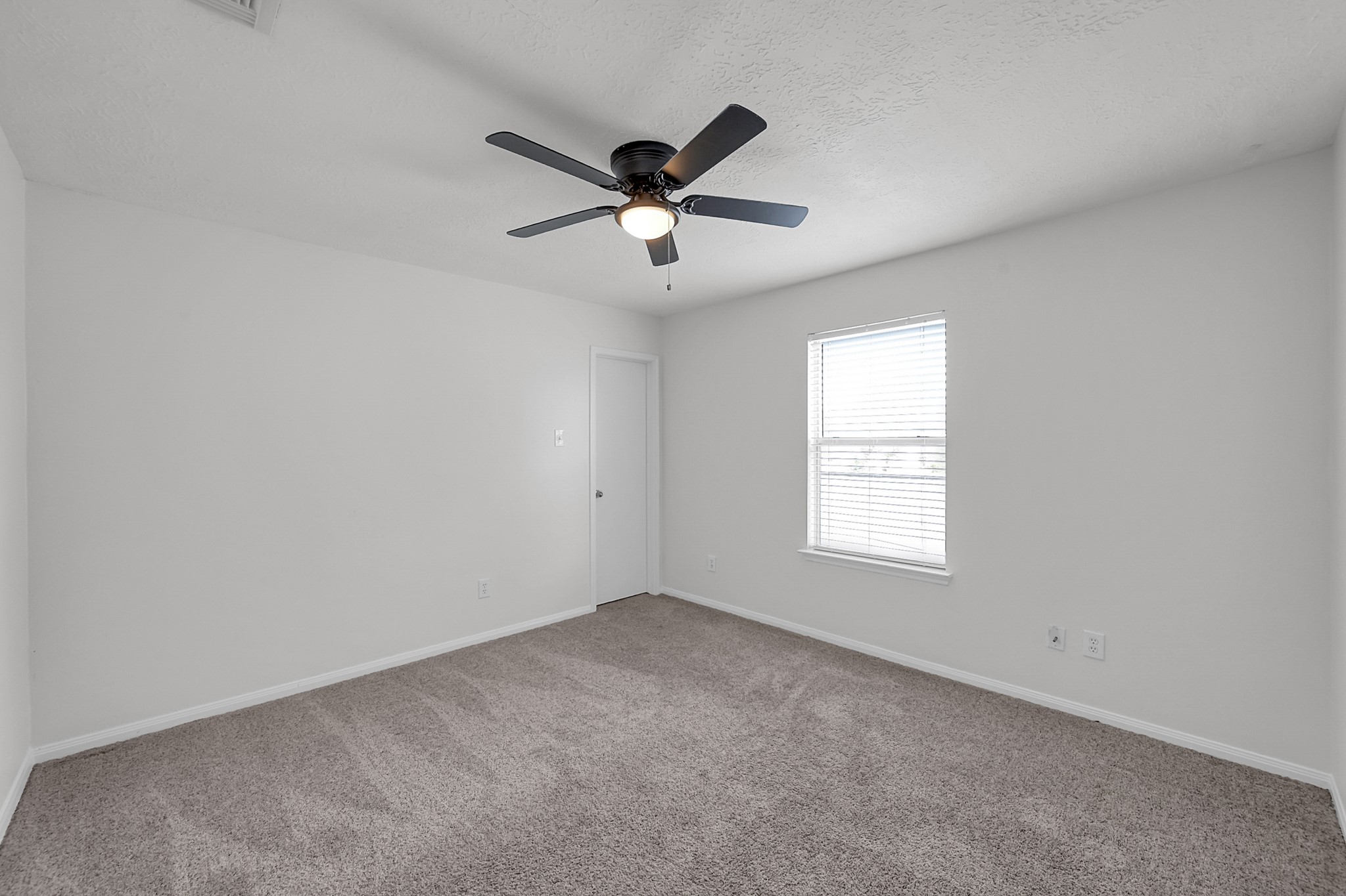 30818 Trinket Drive Spring, TX 77386 - Photo 24 of 29 an empty room with a window and a fan