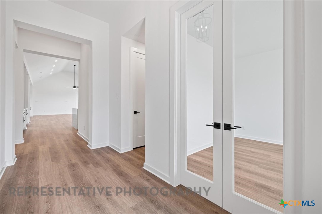 11925 Lofted Bloom Schertz, TX 78154 - Photo 2 of 12 a view of a hallway with wooden floor and entryway