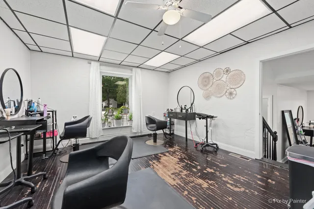 a living room with furniture a flat screen tv and a stove