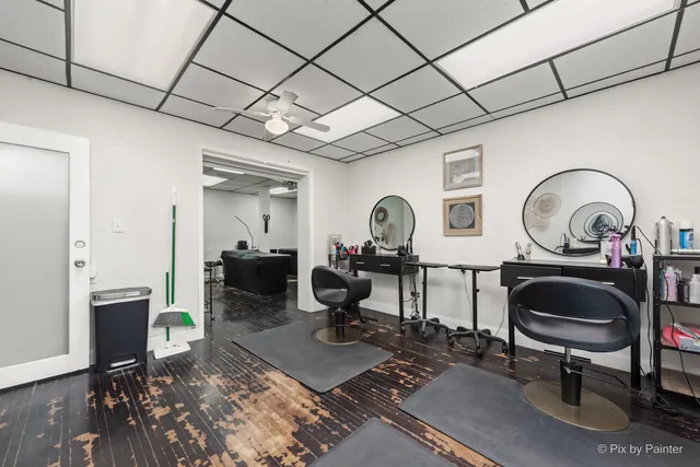 a view of a hallway with wooden floor and entryway