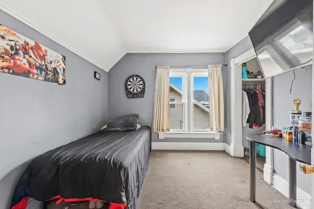 a bedroom with bed and a window