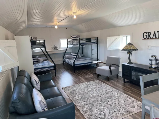 a view of a dining room with furniture and chandelier