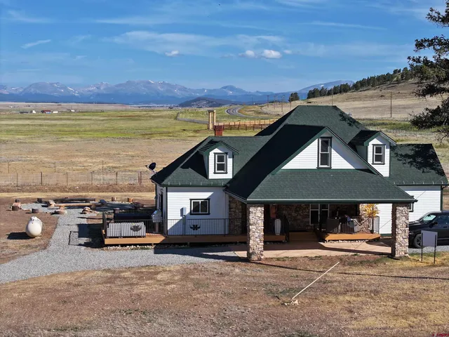 a view of a terrace with a table and chairs under an umbrella