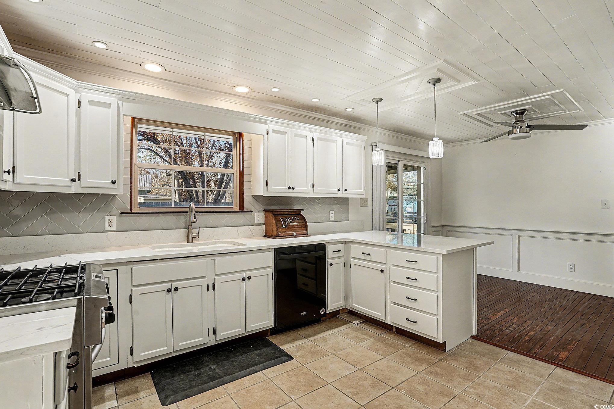 218 Busbee Street Conway, SC 29526 - Photo 11 of 30 Kitchen with ceiling fan, white cabinetry, decorative light fixtures, stainless steel range with gas stovetop, and dishwasher