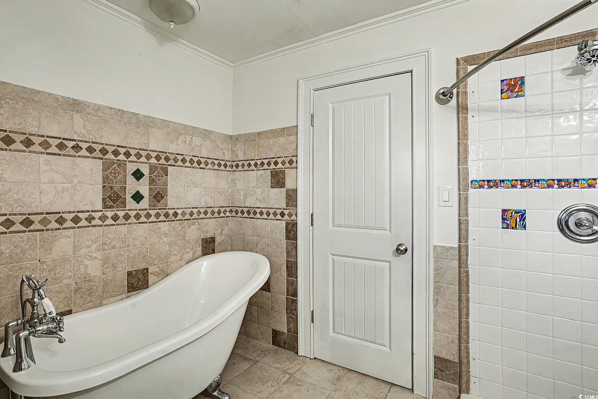 218 Busbee Street Conway, SC 29526 - Photo 17 of 30 Bathroom with a freestanding bath, tile walls, ornamental molding, tiled shower, and tile patterned floors