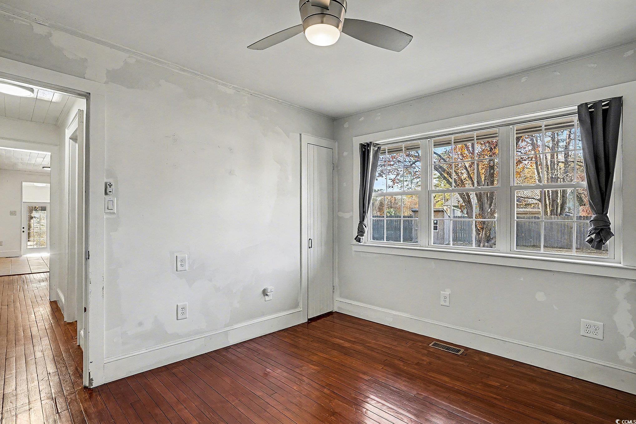 218 Busbee Street Conway, SC 29526 - Photo 19 of 30 Spare room featuring dark wood finished floors, healthy amount of natural light, and ceiling fan