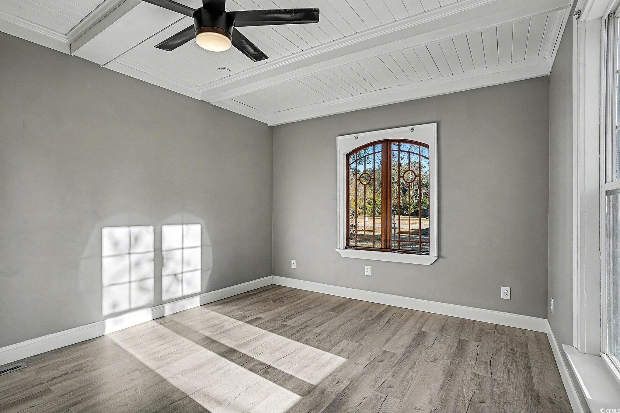 218 Busbee Street Conway, SC 29526 - Photo 21 of 30 Spare room featuring a wood ceiling with exposed beams, light wood finished floors, and a ceiling fan
